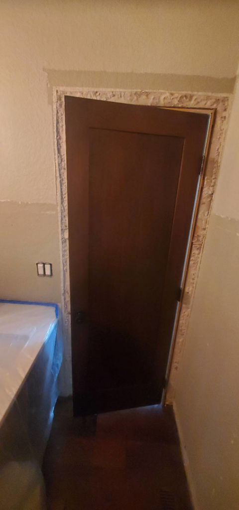 Door frame repair and trim work in a bathroom by Justin-case Repairs in Ankeny, IA.