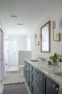 A bathroom featuring a double vanity with dark cabinets and marble countertops installed by Counter Fitters in Savannah, GA