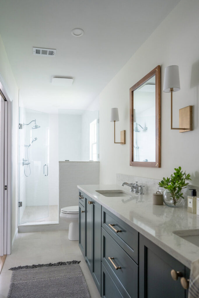 A bathroom featuring a double vanity with dark cabinets and marble countertops installed by Counter Fitters in Savannah, GA