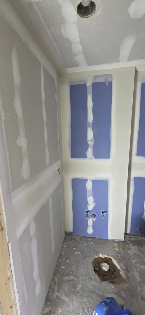 Bathroom renovation with new drywall finishing and plumbing rough-ins by AJ's Drywall & Finishing, LLC in St. Louis, MO.