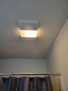 A new bathroom exhaust fan and light fixture installed on the ceiling by McCarran Handyman Services in Boulder City, NV.