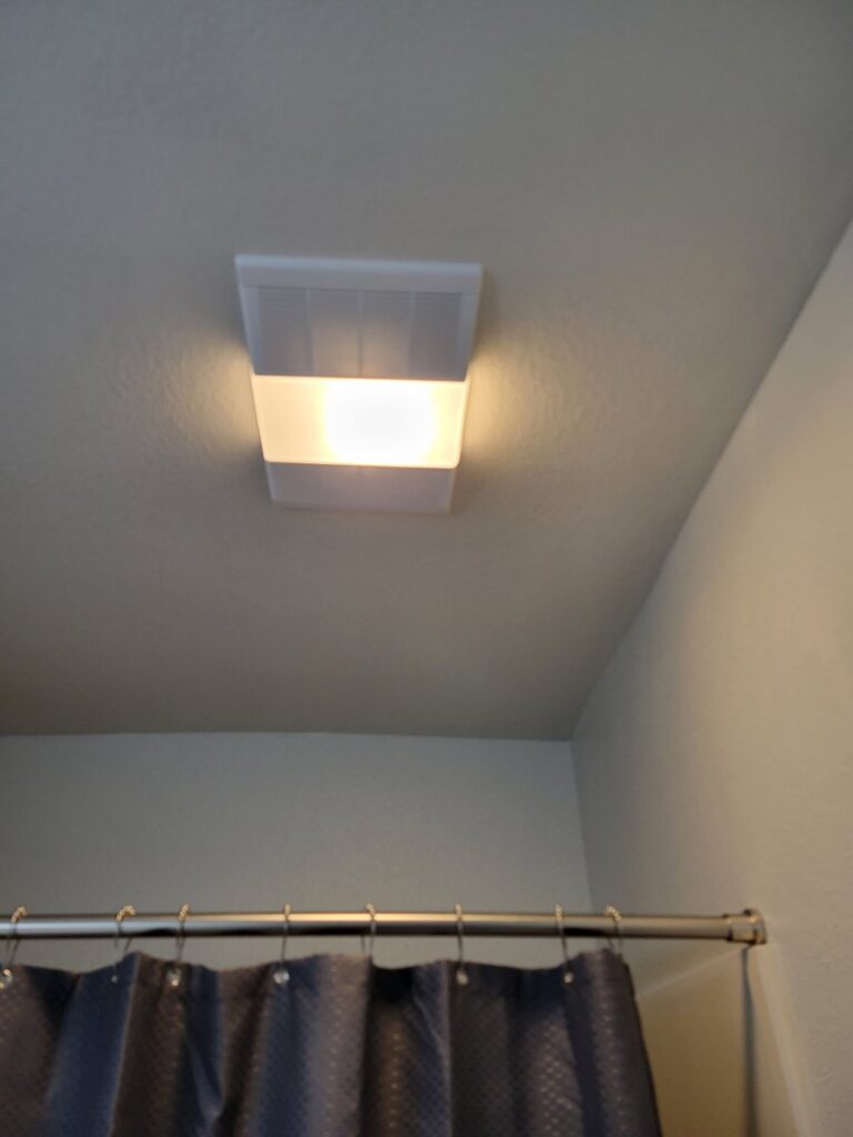 A new bathroom exhaust fan and light fixture installed on the ceiling by McCarran Handyman Services in Boulder City, NV.