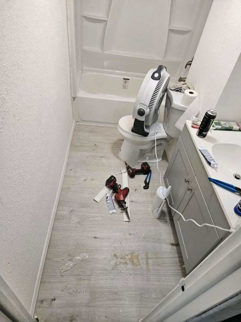 A bathroom undergoing renovation, showing new flooring being installed and fixtures awaiting completion by Mr. Affordable LLC in Denver, CO.