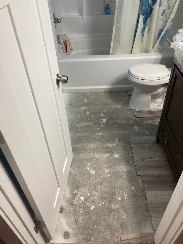 Bathroom floor installation in progress with new tiles by Handyman house repairs and remodeling in Provo, UT