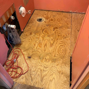 Early stage bathroom floor renovation showing exposed subfloor and plumbing by Mr. Handyman of Charleston and Summerville, Summerville, SC.
