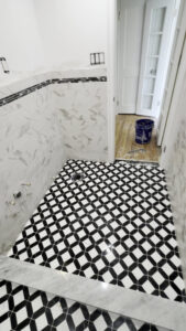 Bathroom floor tile installation with a geometric pattern by Golden Tile Construction in Yonkers, NY.