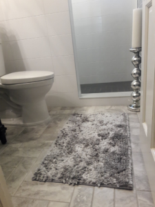Close-up of new bathroom floor tiling and toilet from a remodel by Guaranteed Installations in Tampa, FL.