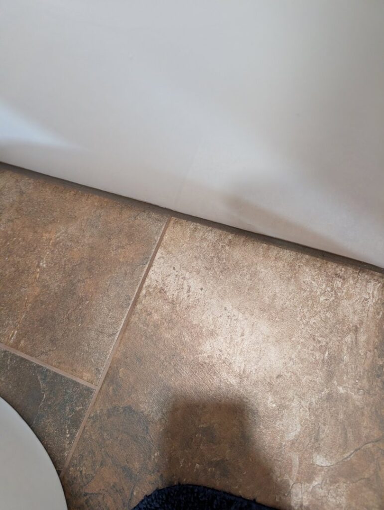 Close-up of newly installed bathroom floor tiles, demonstrating precise work by H4 Construction and Remodeling in Blue Springs, MO.