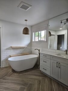 A modern bathroom renovation featuring a freestanding tub and new vanity by Gordon T. Jacob in Tacoma, WA