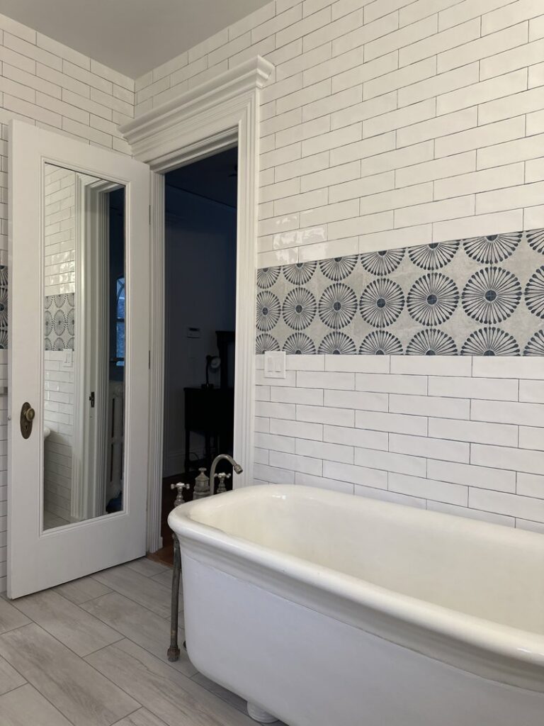 A renovated bathroom featuring a freestanding tub and beautifully tiled walls by Tito's Home Improvement LLC in Stamford, CT.