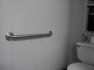A newly installed grab bar on a bathroom wall next to a toilet by Home Solutions of Kansas City in Kansas City, MO
