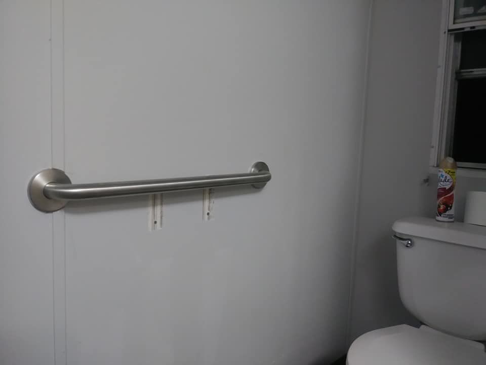 A newly installed grab bar on a bathroom wall next to a toilet by Home Solutions of Kansas City in Kansas City, MO