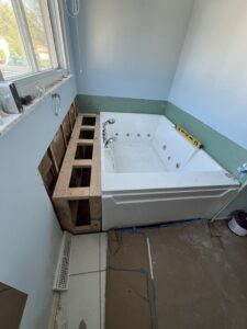 A jetted bathtub installation in progress with visible framing and partial drywall by Jarrett's Home Improvements & Maintenance Services in Columbus, OH