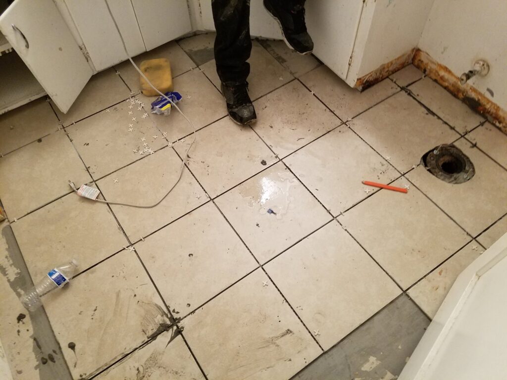 New floor tiling being installed in a bathroom or kitchen by Red Gator Maintenance in Fresno, CA.