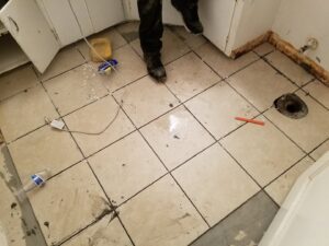New floor tiling being installed in a bathroom or kitchen by Red Gator Maintenance in Fresno, CA.