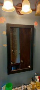 A bathroom mirror medicine cabinet installed above a sink by Arthur brownell jr handyman in Attleboro, MA