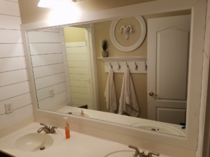 A newly installed large bathroom mirror and shiplap wall by Little Blue Handyman in Henderson, NV.