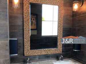 Bathroom mirror and vanity installation with modern fixtures by J and R Granite Industry in Columbus, OH.