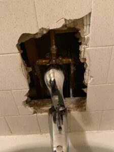 Bathroom plumbing repair and renovation in progress, showing exposed pipes and faucet, by Vargas Paint and Texture in San Antonio, TX.