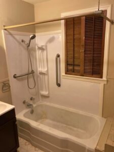 A remodeled bathroom featuring a bathtub, shower, and installed grab bars for accessibility by AON Construction and Remodeling LLC in Wichita, KS.