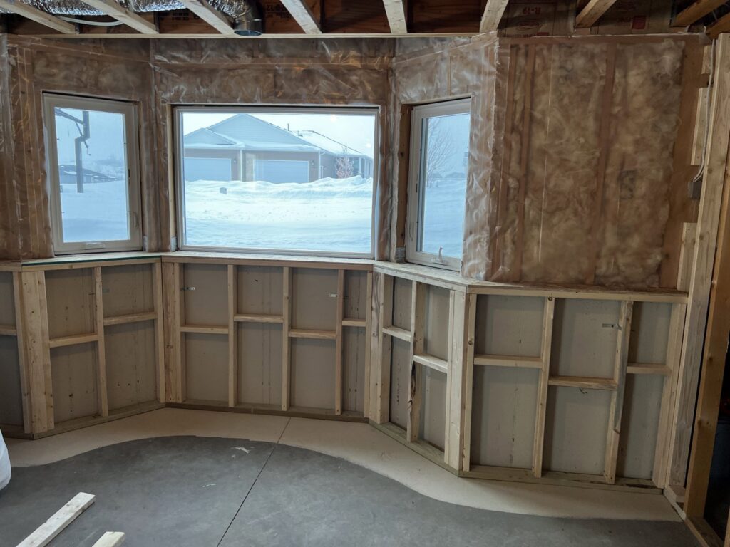 A renovated bathroom featuring new built-in cabinets and a stylish shower surround by ROTH WORX LLC in Bismarck, ND.