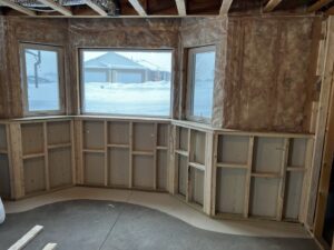 A renovated bathroom featuring new built-in cabinets and a stylish shower surround by ROTH WORX LLC in Bismarck, ND.
