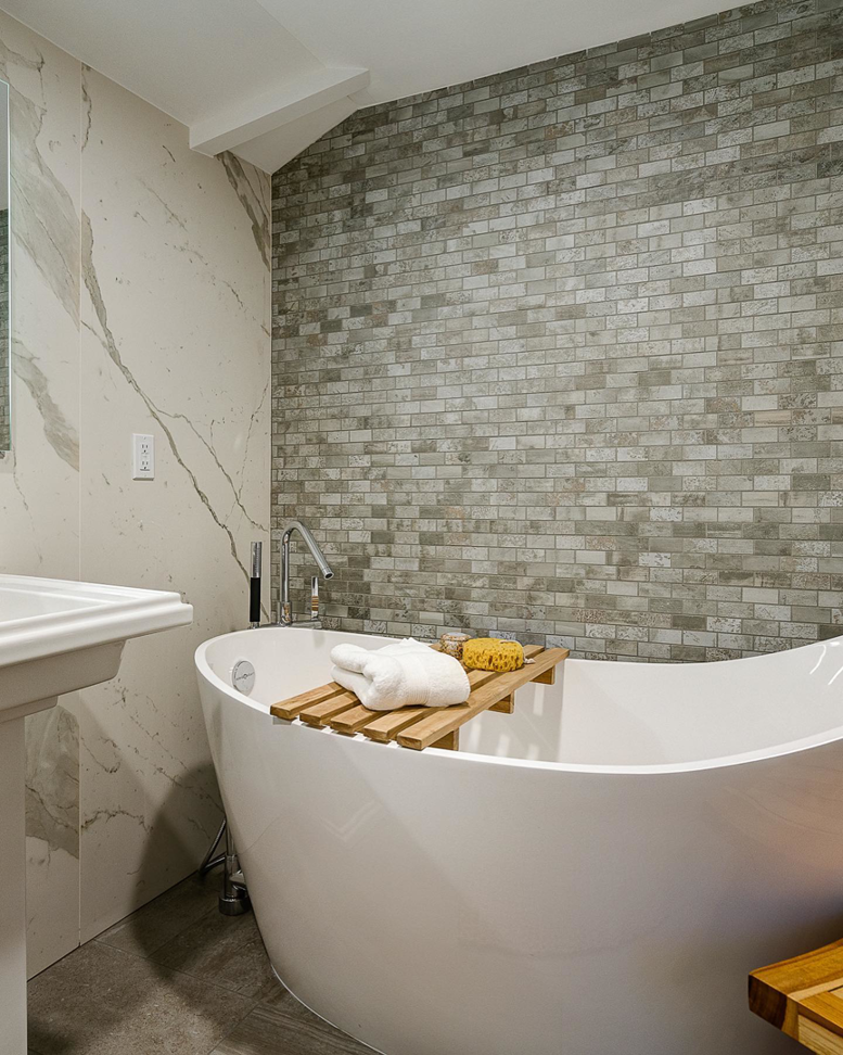 A modern bathroom remodel featuring a freestanding tub and tiled walls by Scott Hall Remodeling in Columbus, OH.