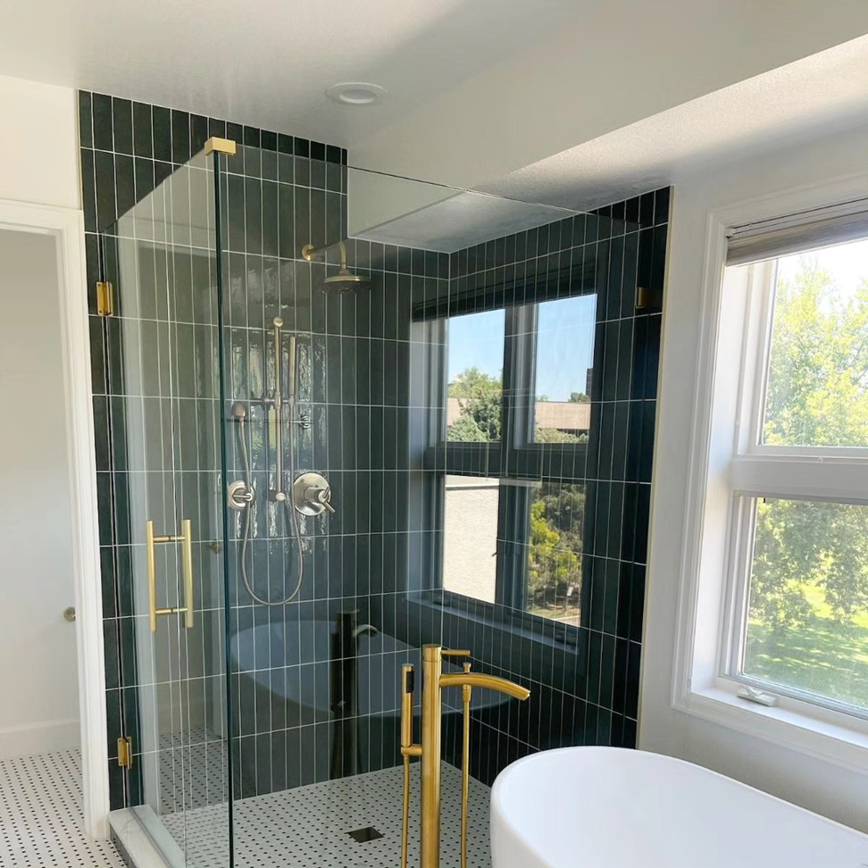 A complete bathroom remodel featuring a glass shower enclosure and freestanding tub by Buerger Brothers Construction in Lakewood, CO.