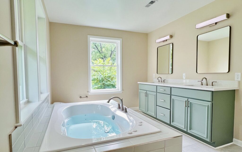 A spacious bathroom remodel featuring a jetted tub and a double vanity by Dream Design Build & Remodeling, Inc. in Baltimore, MD