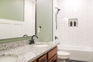 Bathroom remodel with subway tile shower, double vanity, and new fixtures by Prestige Remodeling Solutions in Jackson, TN.
