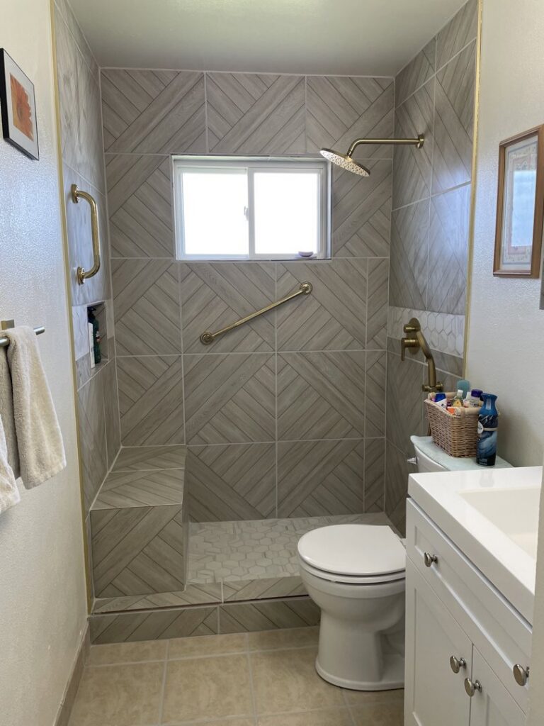A beautifully remodeled bathroom featuring a tiled walk-in shower by HandyMation in Cheyenne, WY