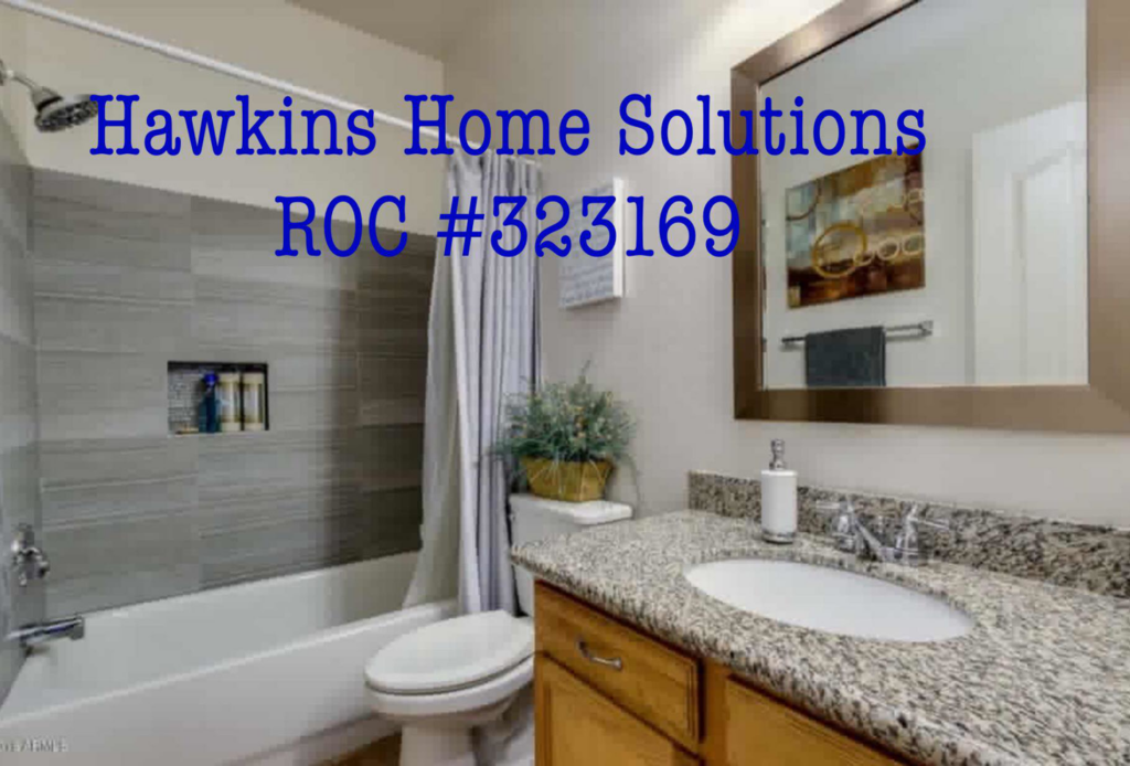 A beautifully remodeled bathroom featuring a tiled shower and granite vanity by Hawkins Home Solutions in Glendale, AZ.