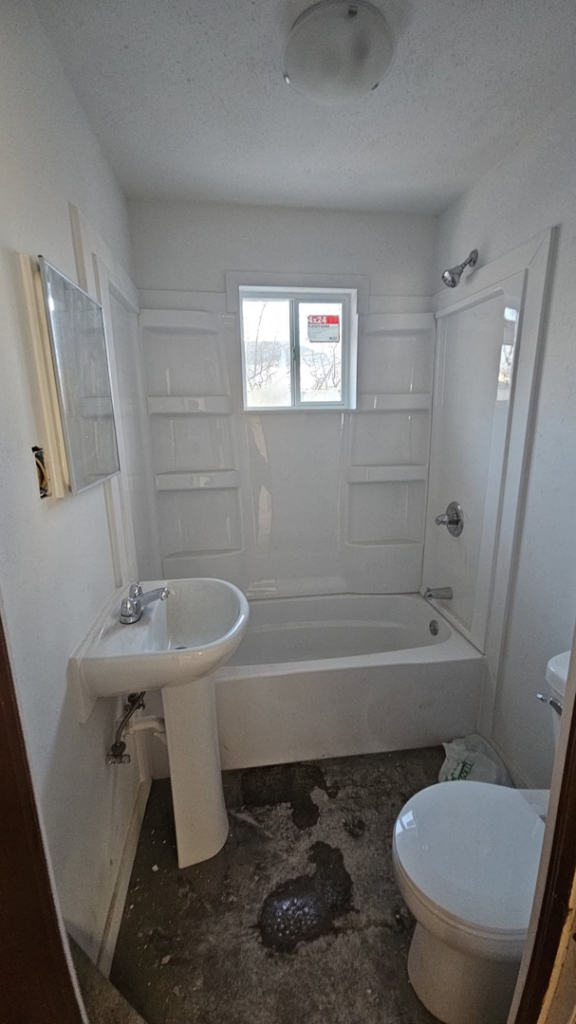 Bathroom remodel with new tub, sink, and toilet installation by Clausen Construction LLC in Williston, ND