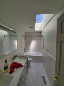 A modern bathroom remodel featuring a new vanity, subway tile shower, and skylight by Lilac Remodel Spokane in Spokane Valley, WA.