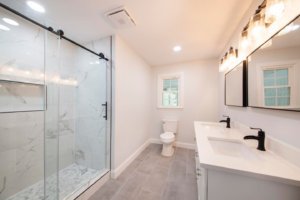 A contemporary bathroom remodel with a walk-in shower and double vanity completed by D and R Professional Home Services in Services Available In.