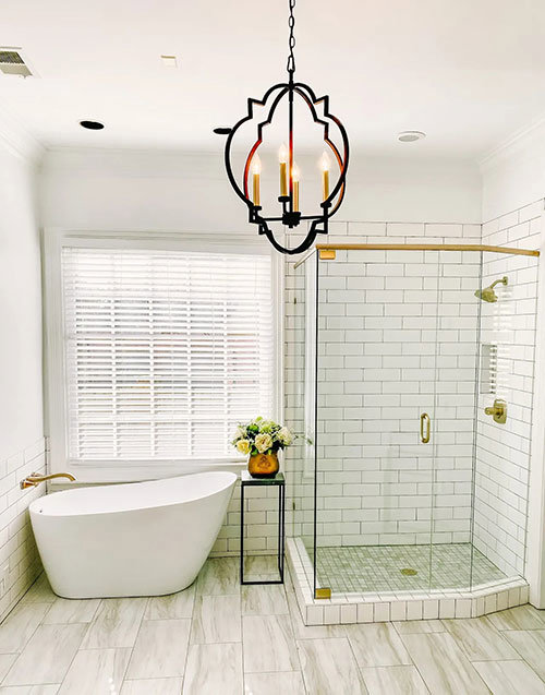 A bathroom remodel featuring a freestanding tub and a walk-in shower with white subway tiles by CMT Construction LLC in Columbia, MO.
