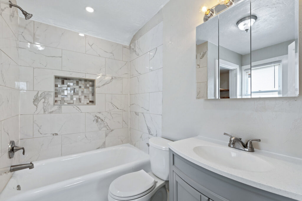 A renovated bathroom featuring white subway tile and a new vanity by Integrated Contracting and Renovations in Pittsburgh, PA.