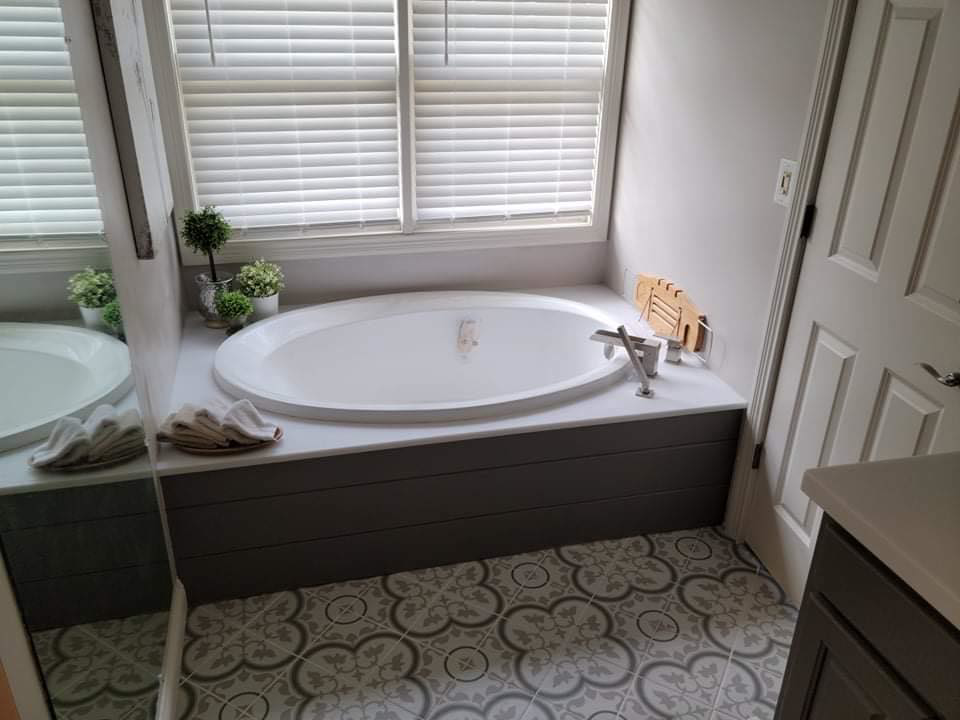 Remodeled bathroom with new built-in bathtub and patterned tile floor by Carter's Handyman Service and Remodeling in Bloomington, IN.