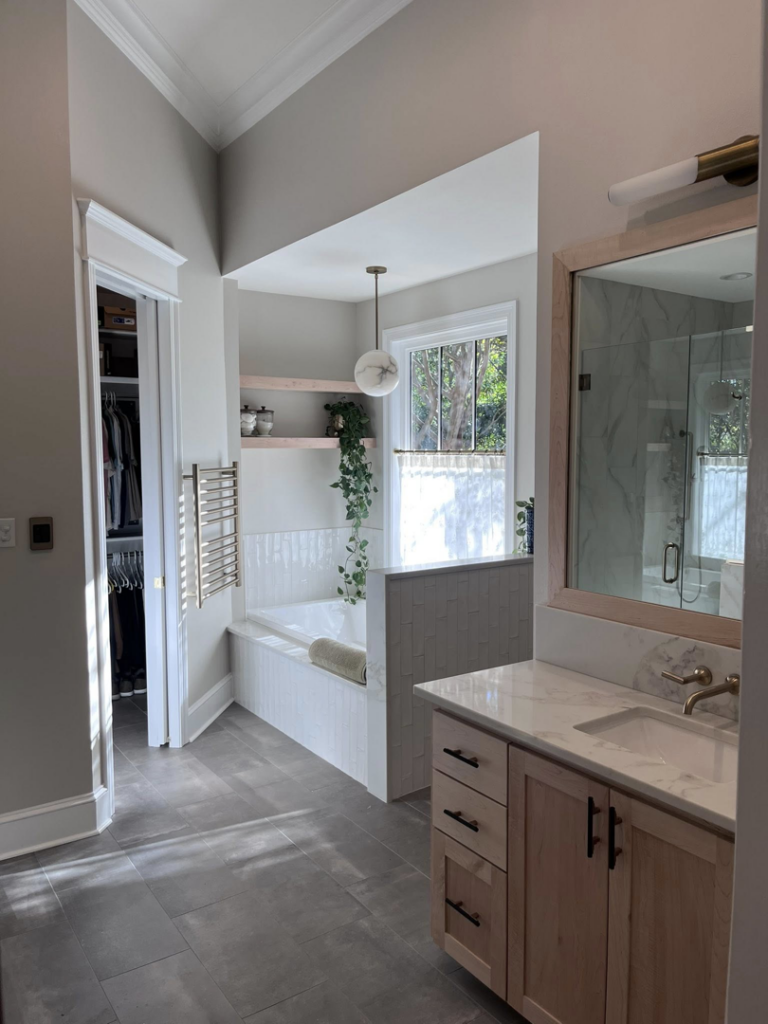 A renovated bathroom with a new bathtub and vanity completed by Ourso Renovations in Baton Rouge, LA
