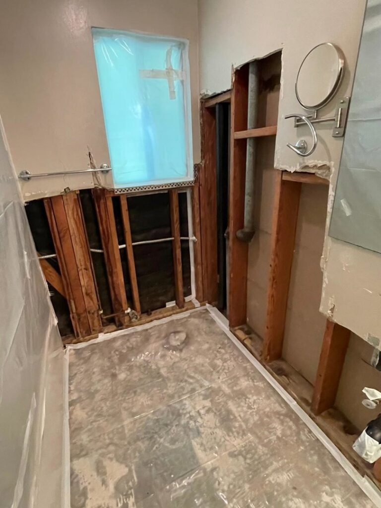 A bathroom undergoing renovation with exposed studs and plumbing, handled by DemoCraft Commercial Services in Everett, WA