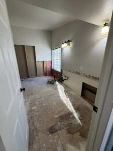 A bathroom undergoing renovation with walls removed, showing exposed studs and plumbing by CK Customs LLC in Surprise, AZ.