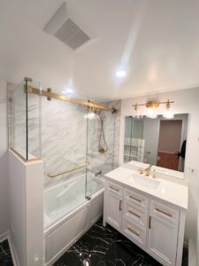 A newly renovated bathroom featuring a modern glass shower enclosure installed by MW Glass in Stamford, CT.
