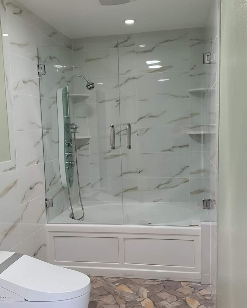 A beautifully renovated bathroom featuring a tiled shower and glass enclosure by Total Improvements LLC in San Antonio, TX.