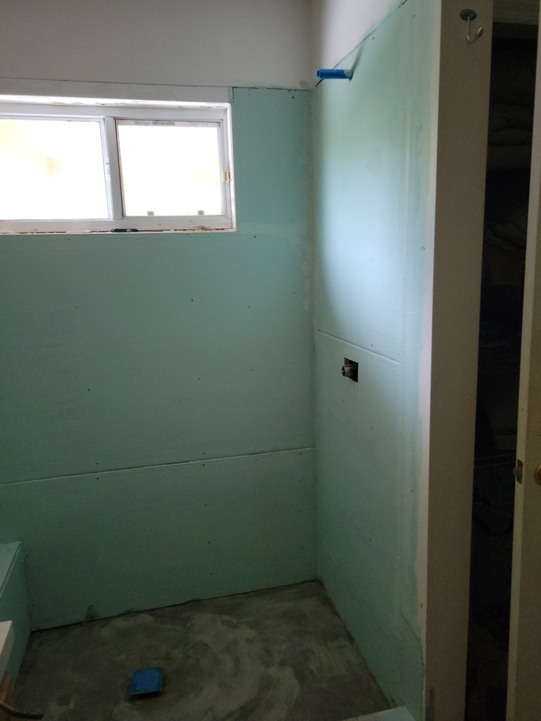 Bathroom renovation in progress with green board installed, ready for tiling by Williams Custom Construction in Orlando, FL.