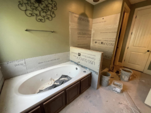 Bathroom renovation in progress, showing a new bathtub and cement backer board installed by RIBAM Residential contractor.llc in Auburn, AL.