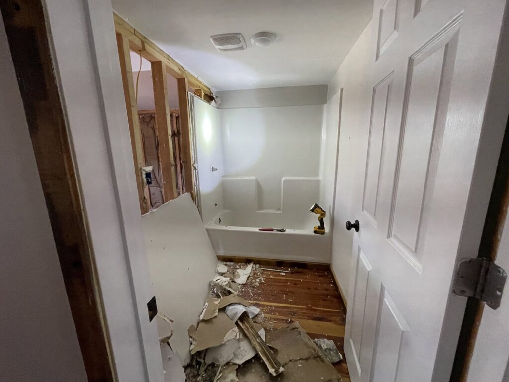 A bathroom renovation in progress with new tub surround and exposed studs by BK's Handyman Services in Carlton, OR.