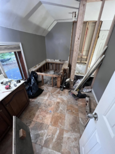 A bathroom undergoing renovation, with walls open to studs and plumbing visible, showcasing a project by Great Home Construction LLC in Annapolis, MD.