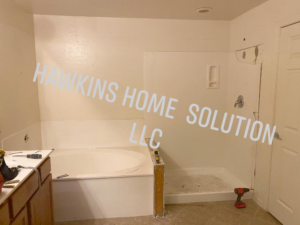 A bathroom renovation in progress with a new tub and shower pan by Hawkins Home Solutions LLC in Glendale, AZ.