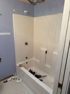 A bathroom renovation in progress, showing a newly installed tub and unfinished walls, by JP. Remodel Service LLC in Everett, WA.