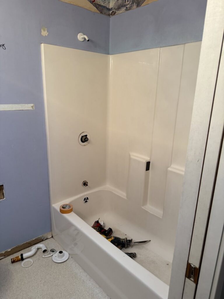 A bathroom renovation in progress, showing a newly installed tub and unfinished walls, by JP. Remodel Service LLC in Everett, WA.